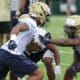 Jordan Whitehead works with other DB during the first practice of the season (Photo credit: David Hague)