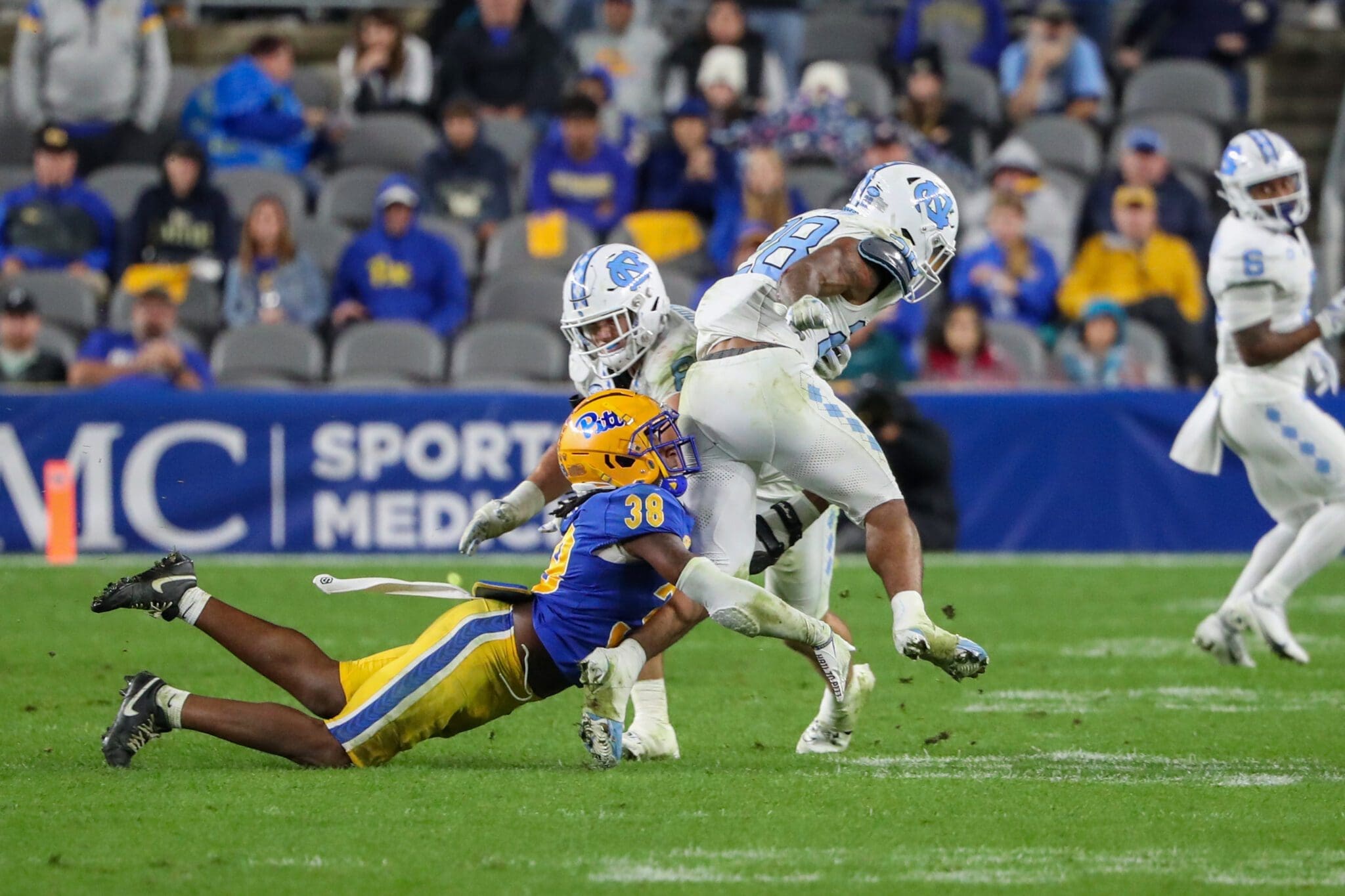 Pitt linebacker Kyle Louis tackles UNC running back Omarion Hampton.