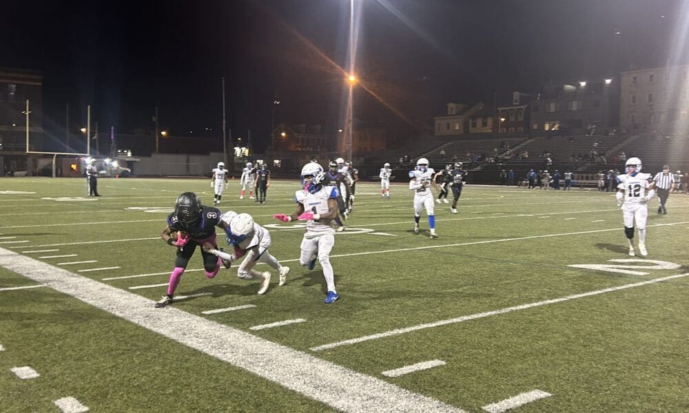 City League University Prep receiver Brandon Masie heads out of bounds after picking up a first down.