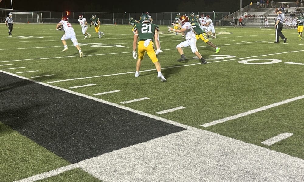 North Catholic cornerback Ryan Snyder (21) steps in front of and intercepts a pass in the fourth quarter of the Trojans' season opening loss to Seton LaSalle.