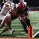 Imhotep Charter quarterback Mikal Davis dives for the pylon in the 5A PIAA State Championship against Peters Township. Photo by Eddie Provident.