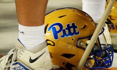 A Pitt football helmet sits at a player's feet during a timeout against Virginia Tech on Saturday, Sept. 30, 2023 in Blacksburg, Virginia. (Mitchell Northam / Pittsburgh Sports Now.)